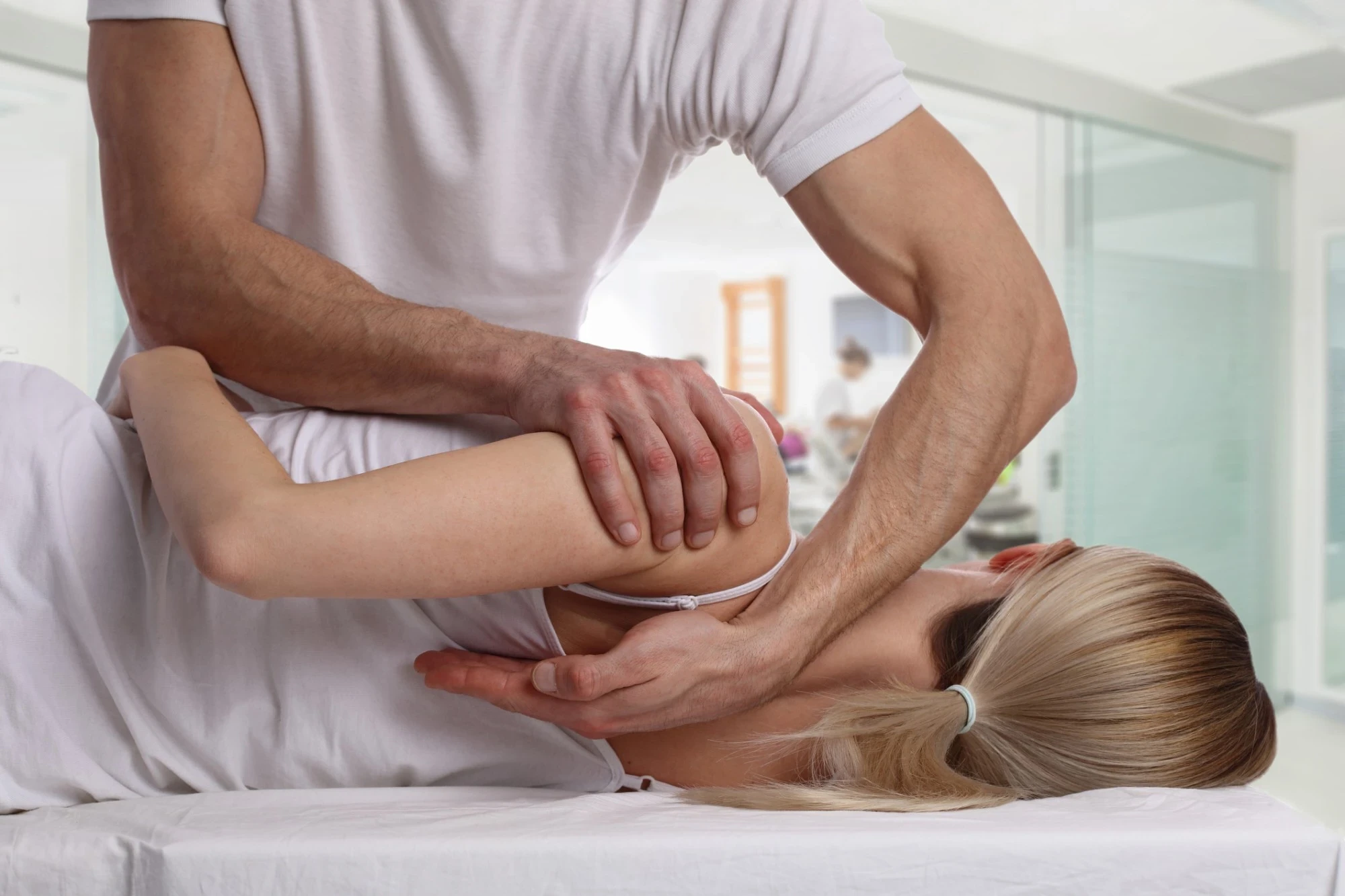 Osteopath providing hands-on shoulder treatment